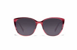 Image of Cheeterz Club eyewear. Photo of cat eye sunglasses with gray tinted lenses. The frames are small with hibiscus pink color and hues of red, suitable for square, oval, and heart shaped face shapes. 