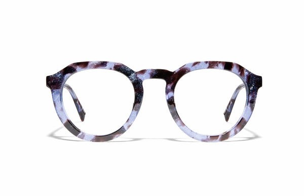 Pictured here is handmade eyewear from Cheeterz Club. It is a medium-sized round-shaped frame in a blue and black spotted print. These are reading Blue Light Blocking glasses with clear lenses. This shape works well with a square, oval, or oblong face shape.