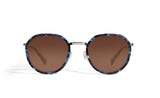 Image of Cheeterz Club eyewear. Photo of round sunglasses with brown tinted lenses. The frames are small width and blue, gray, and black color and a stainless steel frame front. Suitable for square, oval, and oblong shaped face shapes. 