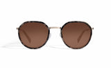 Image of Cheeterz Club eyewear. Photo of round sunglasses with brown tinted lenses. The frames are small width and gray and black color and a stainless steel frame front. Suitable for square, oval, and oblong shaped face shapes. 