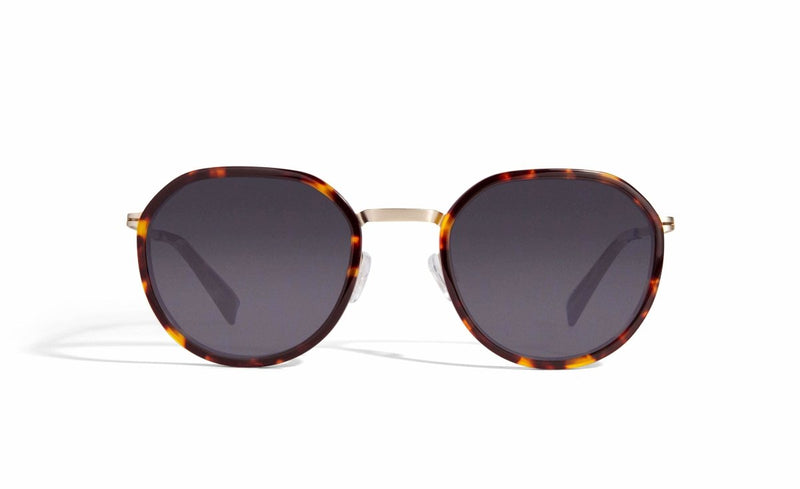  Image of Cheeterz Club eyewear. Photo of retro classic round sunglasses with gray tinted lenses.  The frames are small width and golden brown and mahogany color. Suitable for square, oval, and oblong shaped face shapes. 